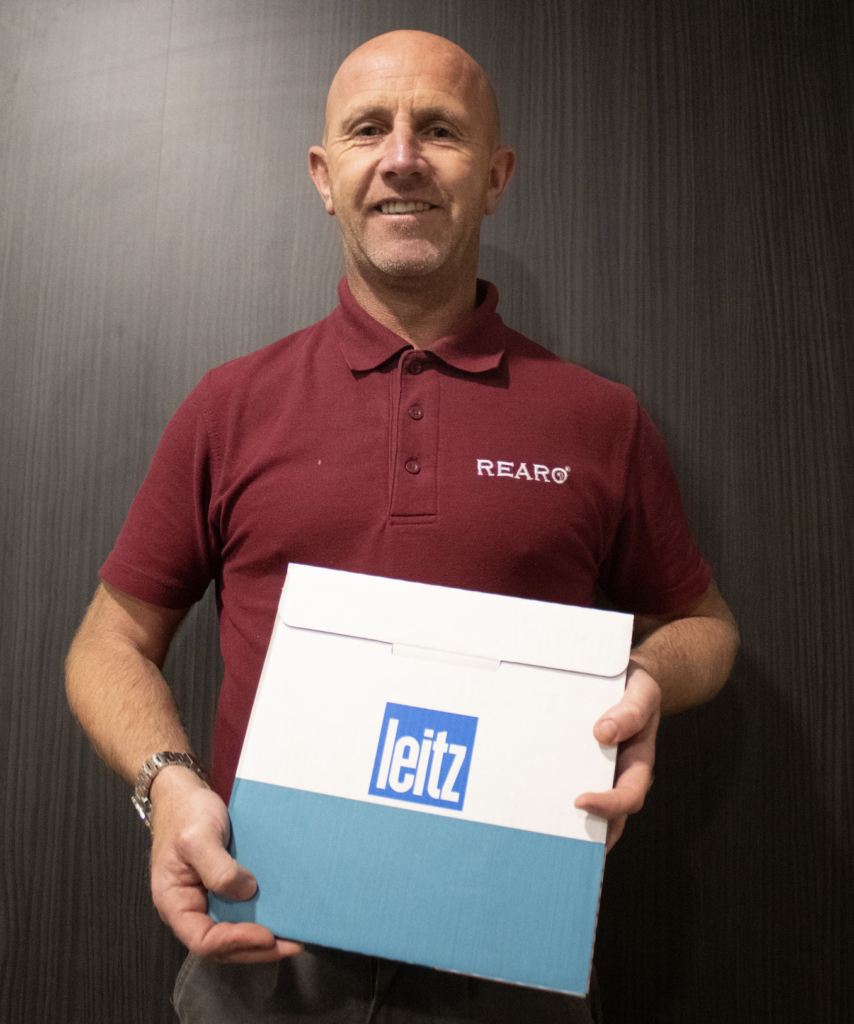 Jamie Campbell holding a Leitz blade in a cardboard box.